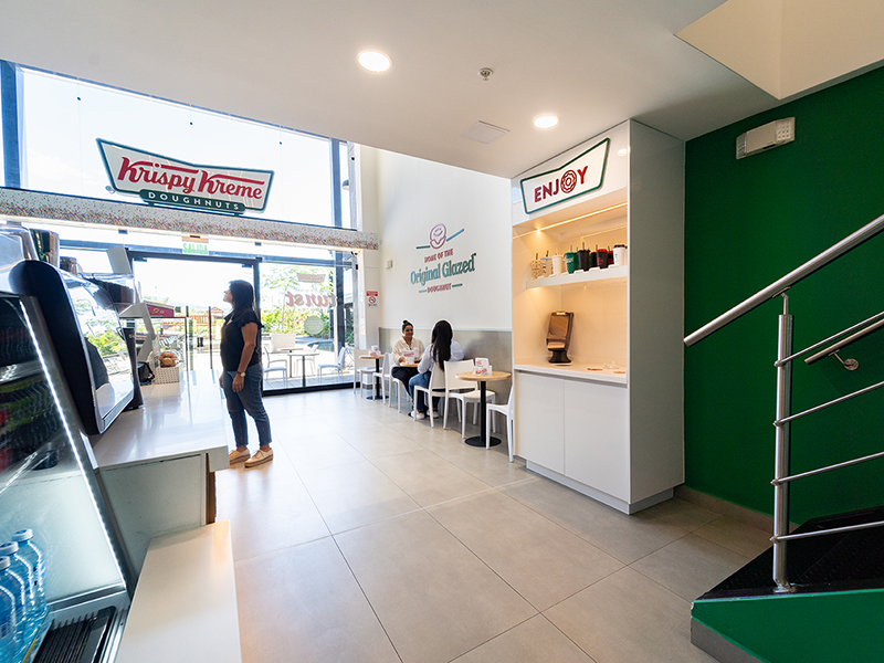Krispy Kreme - Interior entrance view with iconic green branding and double-height ceiling - Contract Workplaces.jpg